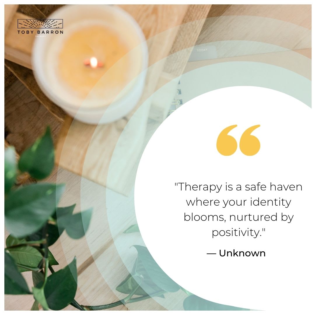 A lit candle on a wooden surface with green leaves and an inspirational quote about therapy.