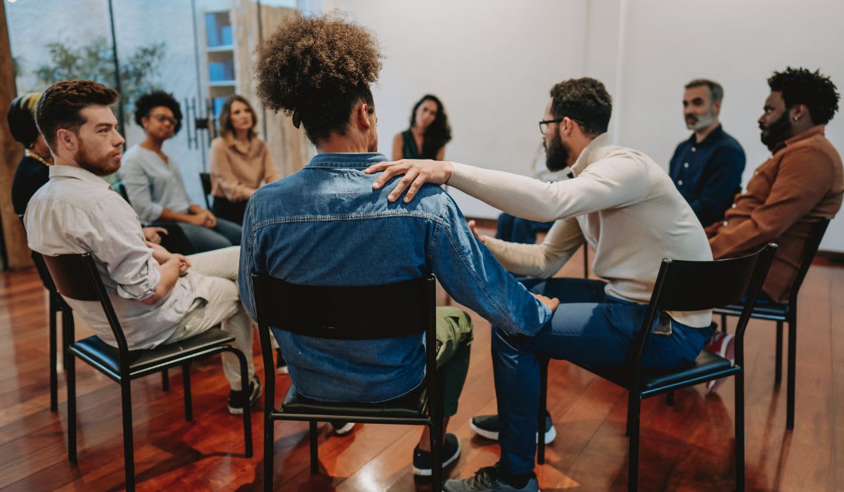 A group of people sitting in chairs in a room.