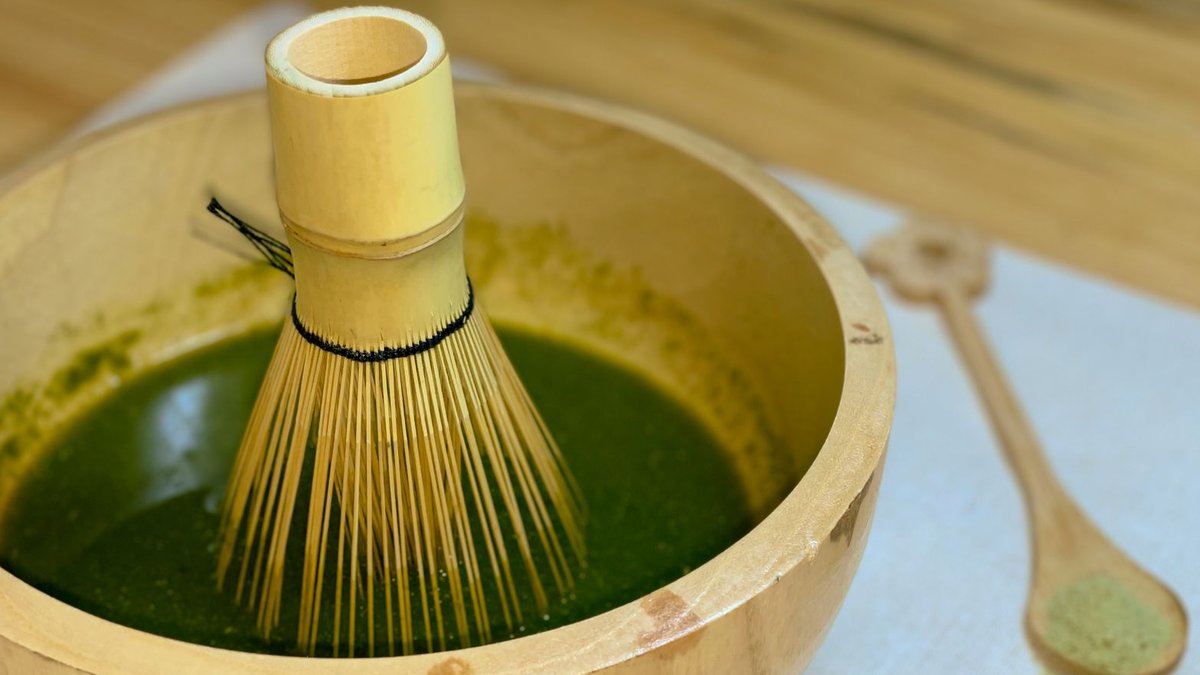 PerfectTed co-founder Marisa Poster speaks to Retail Bulletin A bamboo whisk in a wooden bowl with matcha tea on a wooden surface.
