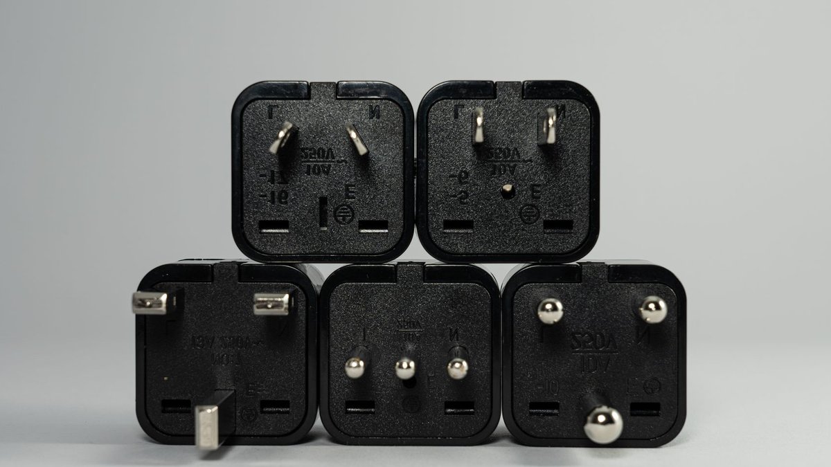 Africa’s economic outlook faces mixed signals A collection of various black international power plug adapters for global electronics use.