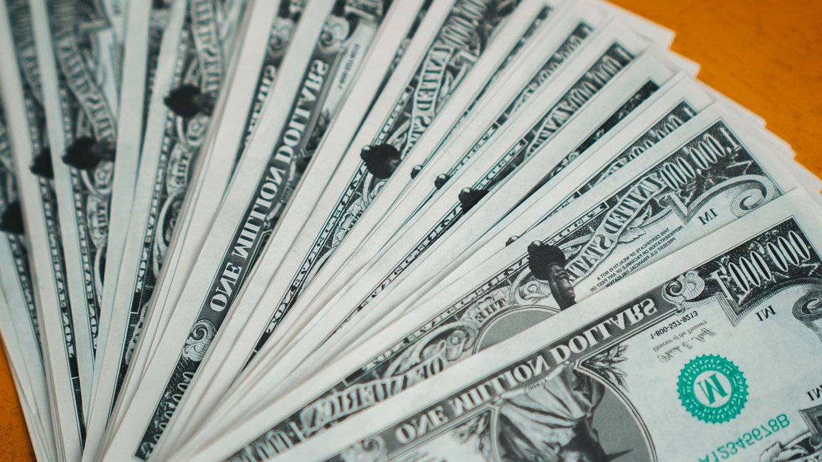 Closeup of novelty one million dollar bills laid out in a fan arrangement.