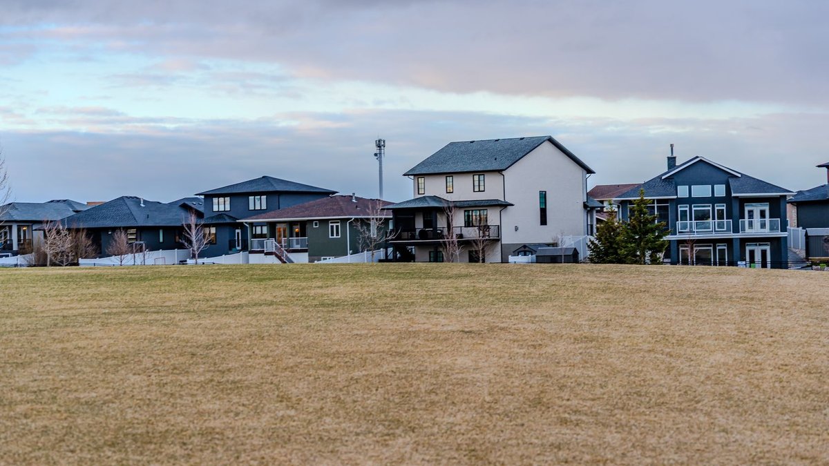 Places for People sees rising profits A view of suburban homes overlooking a vast open field under a partly cloudy sky.