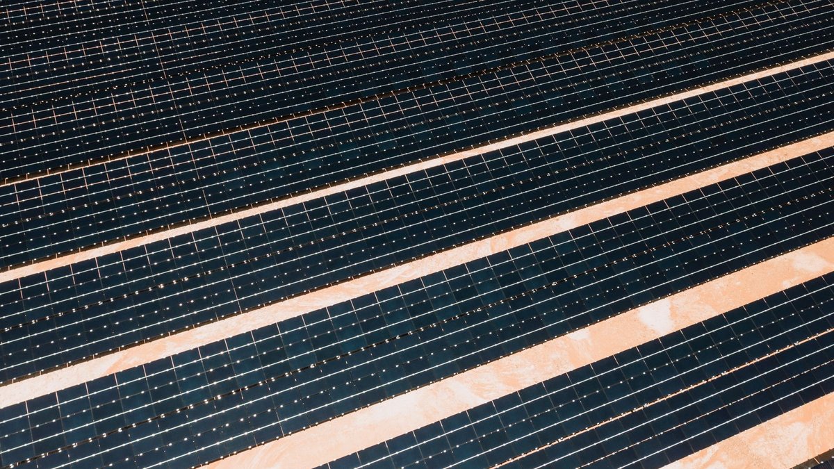 LuxWall expands Detroit plant with DOE funding for energy-efficient windows Aerial shot showcasing rows of solar panels harnessing alternative energy efficiently.