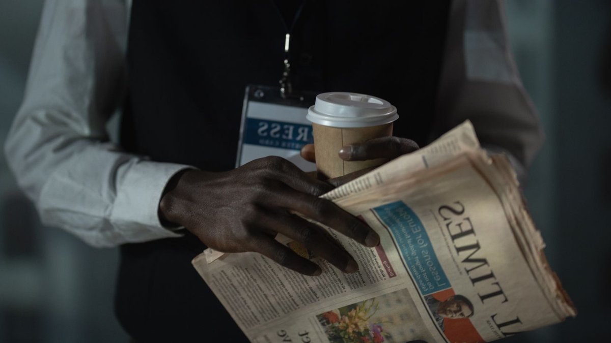 Mona Lisa Theft Spotlight: PR Strategies in AI Era Close-up of a journalist holding a newspaper and coffee cup, conveying press and media concept.