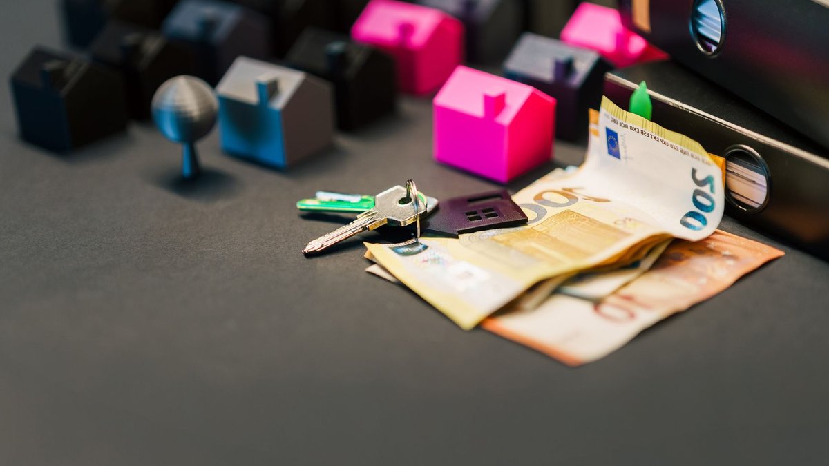 Australian Property Investors Face Major CGT Changes by 2027 Miniature houses, euro bills, and a house key symbolize real estate investment and property transactions.
