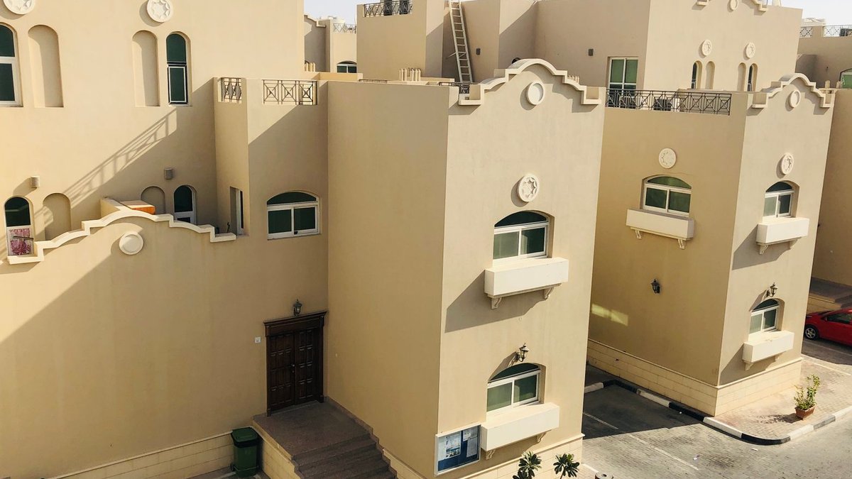 Abu Dhabi delays occupancy certificate deadline for builders Aerial view of modern architectural homes in Abu Dhabi on a sunny day.
