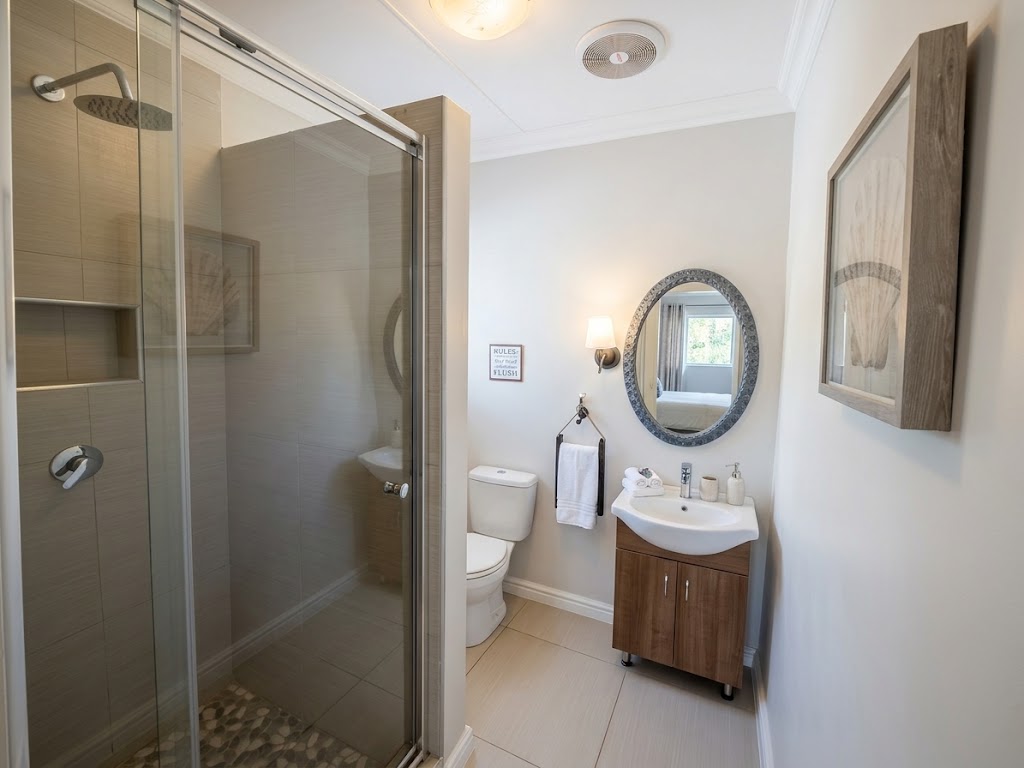 Guest en-suite with glass shower and timber vanity