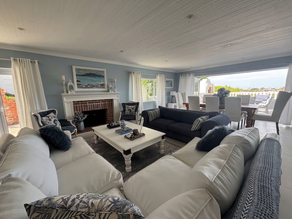 The Grand Lounge at Seeviews Villa with sofas arranged around the fireplace
