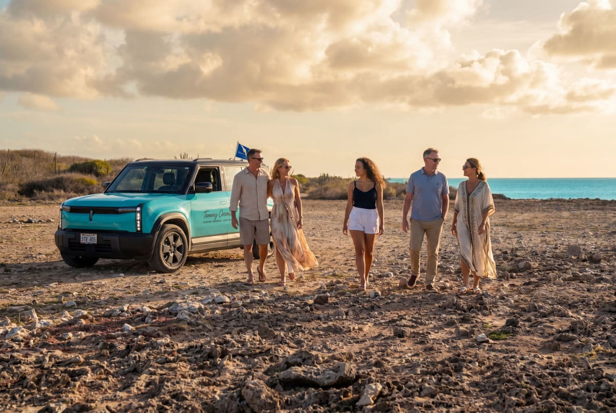 Exploring Curaçao’s coast with the turquoise Tommy Coconut SUV.