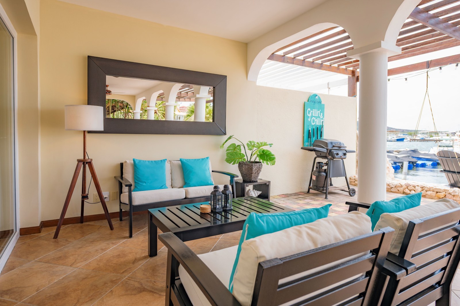 Outdoor area at Sailaway Beach — BBQ, hammock, and sun loungers.
