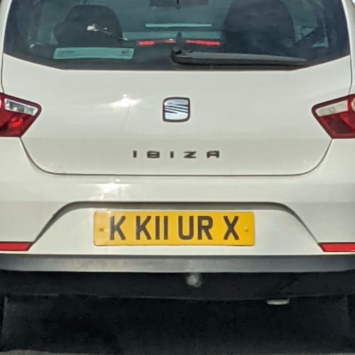 A close-up of a car number plate