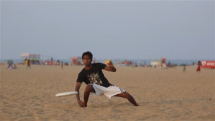 Kids playing frizbee on the beach