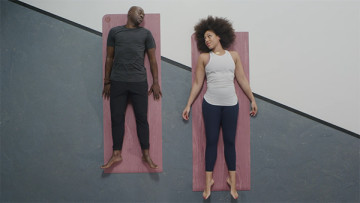 Two athletes lying on yoga mats
