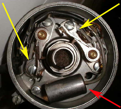 Top view of ignition distributor showing points (yellow arrow) and condensor (red arrow). These parts would require regular replacement to keep your car running properly. This dual point distributor was found on high performance engines.