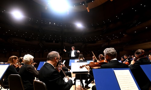 Gustavo Gimeno conducting the TSO with the seats of Roy Thomson Hall behind him