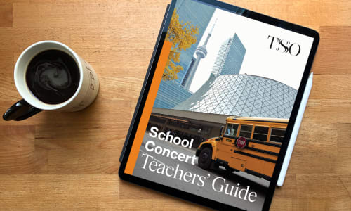 The TSO School Concerts Teachers' Guide is seen on a tablet next to a cup of coffee.