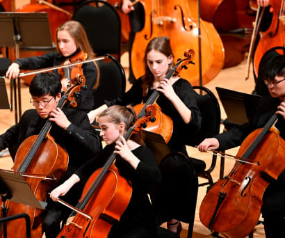 TSYO cellists on stage performing