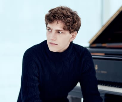 Jan Lisiecki sitting at the piano