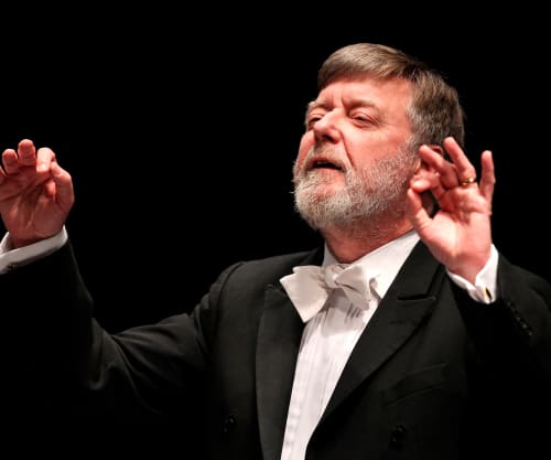 Sir Andrew Davis conducting with his arms raised