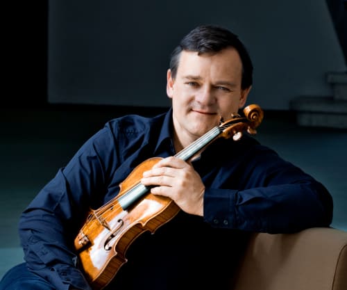 Frank Peter Zimmerman sitting holding their violin