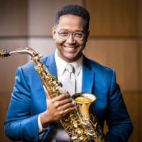 Steven Banks holding an alto saxophone