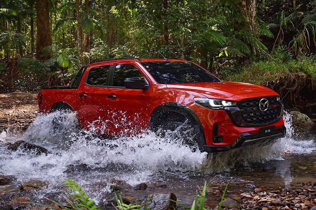 New 2025 Mazda BT-50 driving through a creek