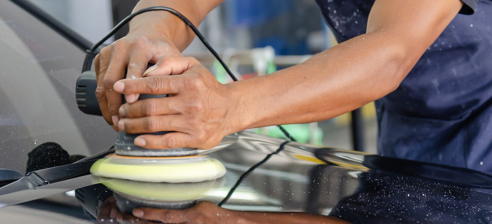 Detailer buffing a car
