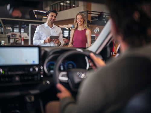 Customer inspecting a new Toyota Yaris GR in a Toyota Showroom