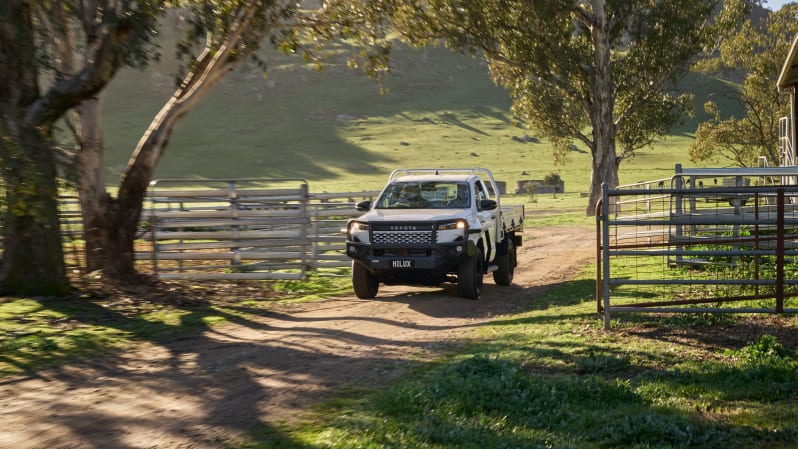 Red 2025 Toyota HiLux parked in rugged Australian bushland