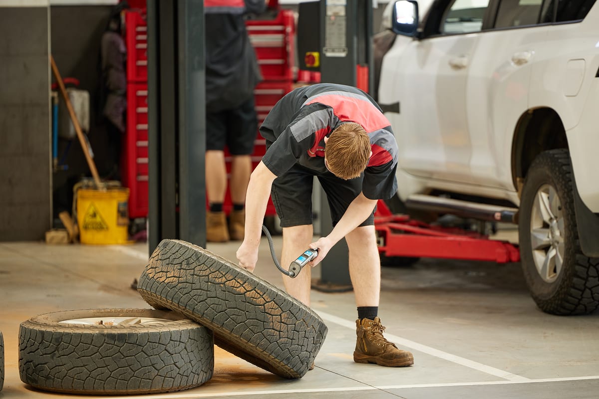 Toyota-trained technician checking tyre tread at New Town Toyota Perth.