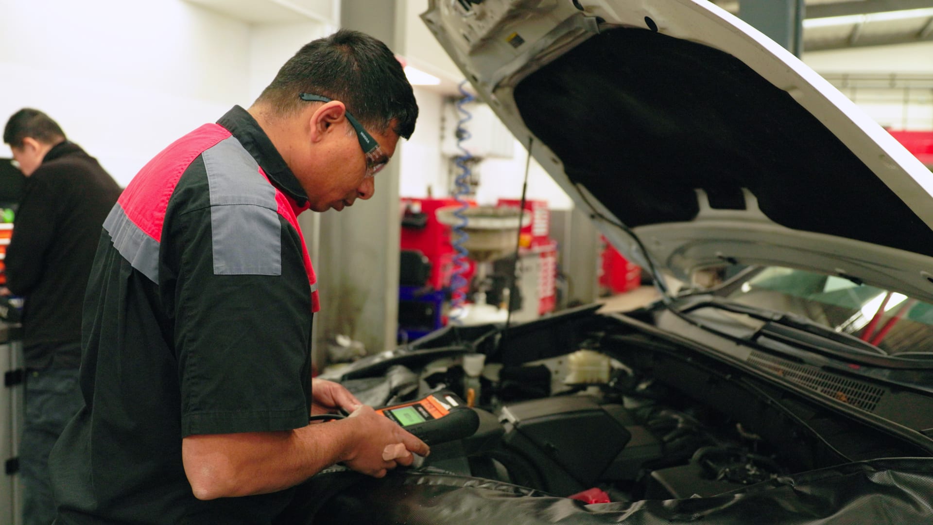 Toyota-trained technician testing a car battery at New Town Toyota Perth.