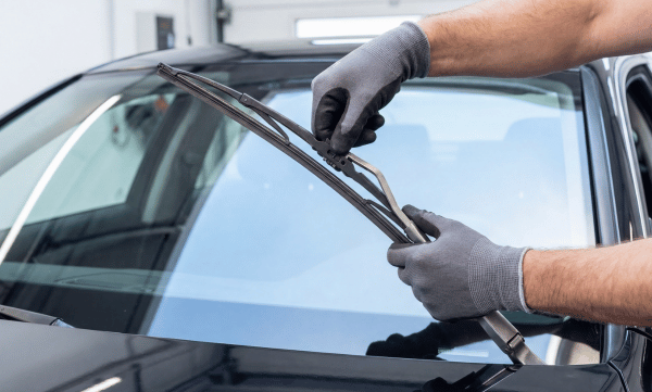 Man replacing windscreen wiper