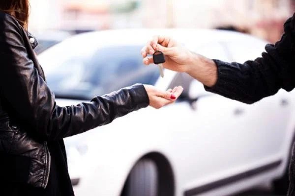 Hand holding car keys