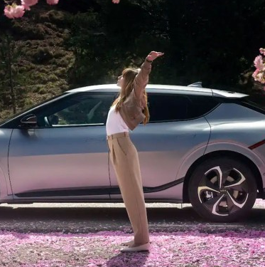 Woman celebrating with new Kia car