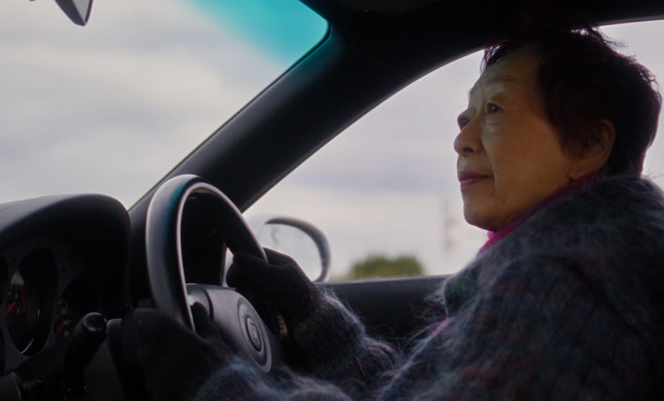 Naoko handles her beloved RX-7 with precision. Her expert technique makes light work of narrow roads and tricky parking, shifting gears with the smooth confidence of a seasoned driver.