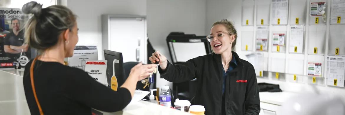 Happy Motorama Kia customer getting keys to new car