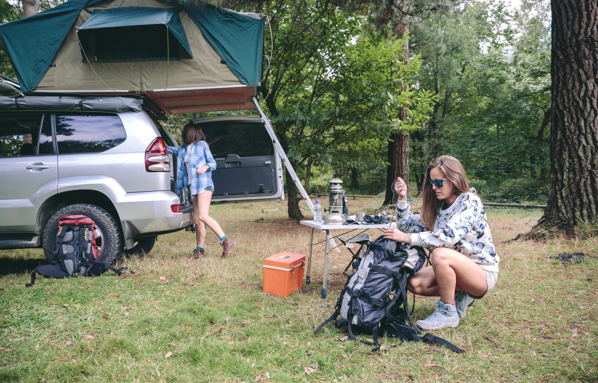 &nbsp; Two women camping with a 4WD and rooftop tent in a forest setting, ideal setup for long-term off-road travel and around-Australia adventures&nbsp;&nbsp;