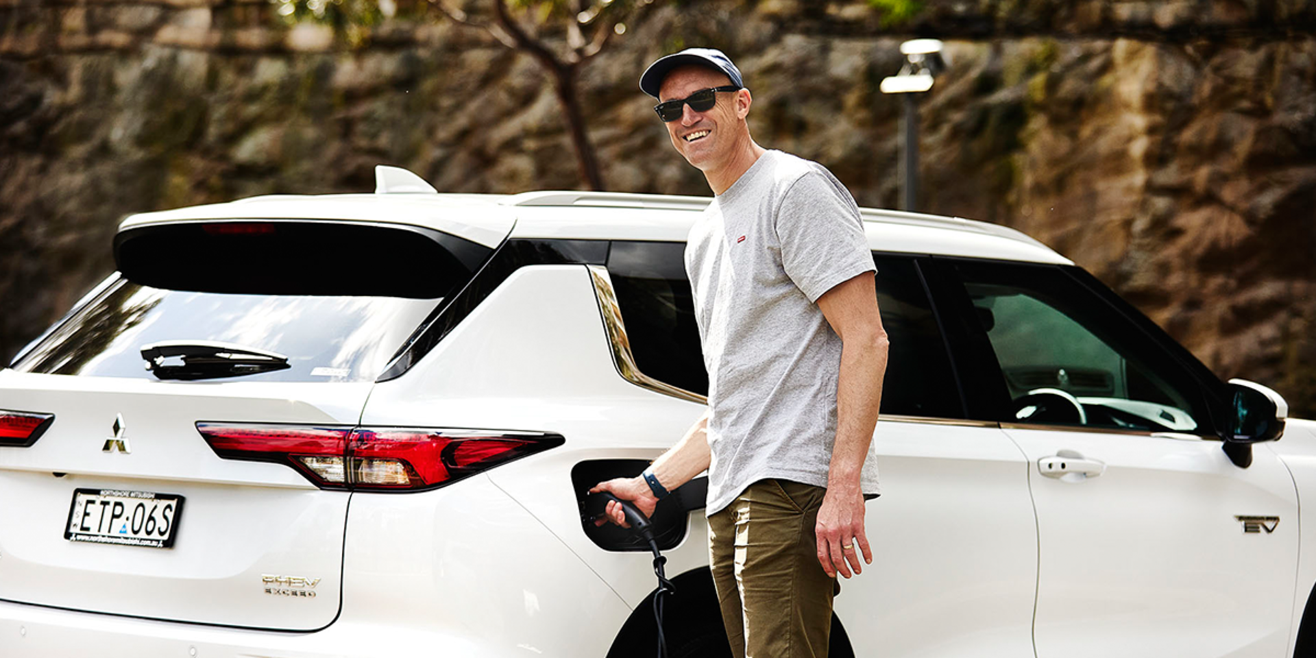 Fitzy from Nova FM behind the wheel of his Mitsubishi Plug-in Hybrid EV banner