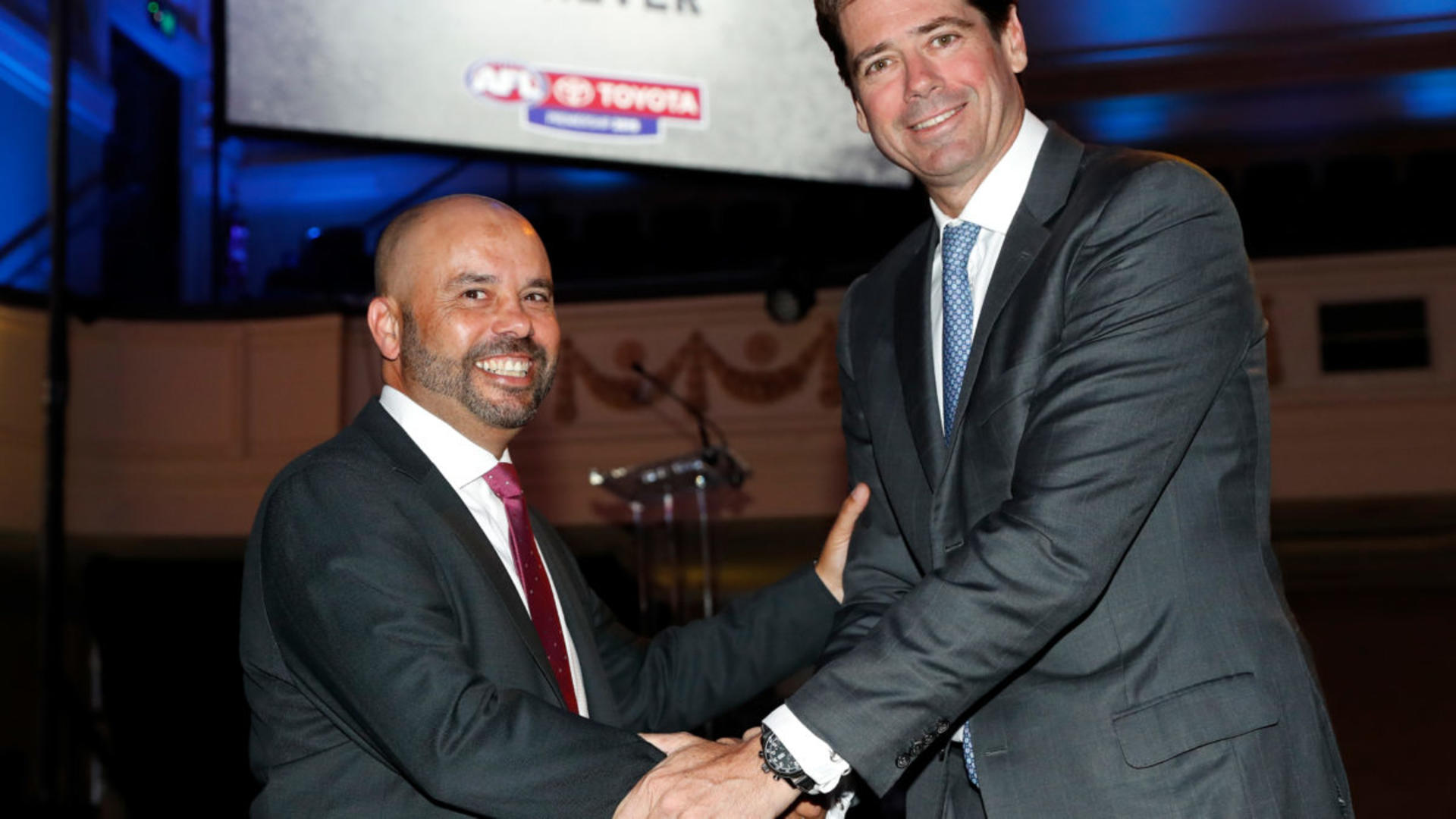 MELBOURNE, AUSTRALIA - MARCH 14: Wayne Gabriel of Toyota (left) and Gillon McLachlan, Chief Executive Officer of the AFL (right) shake hands after announcing a sponsorship extension during the 2019 Toyota AFL Premiership Season Launch at Melbourne Town Hall on March 14, 2018 in Melbourne, Australia. (Photo by Michael Willson/AFL Media)