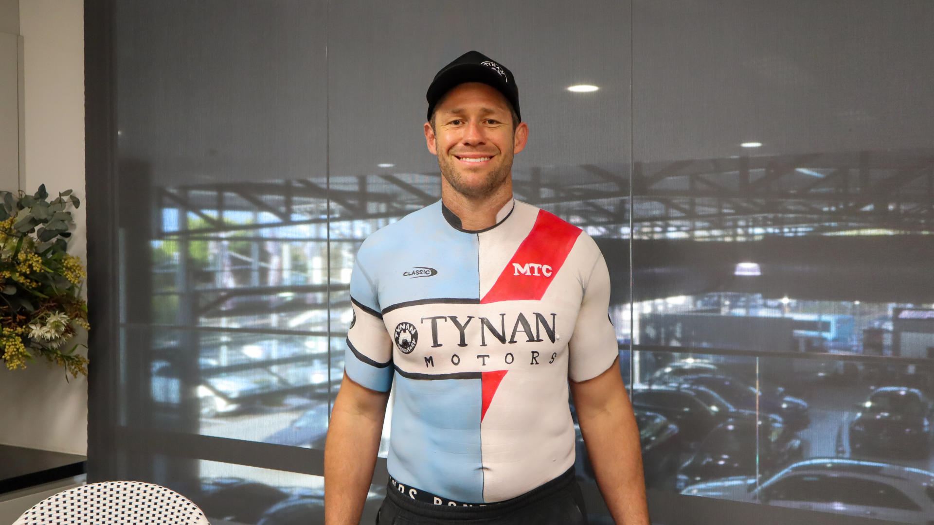 <i>Former NRL legend Jeremy Latimore, is uniquely body painted in a striking half Sharks, half Dragons jersey by the talented Julie Tattam to celebrate the upcoming match.</i>