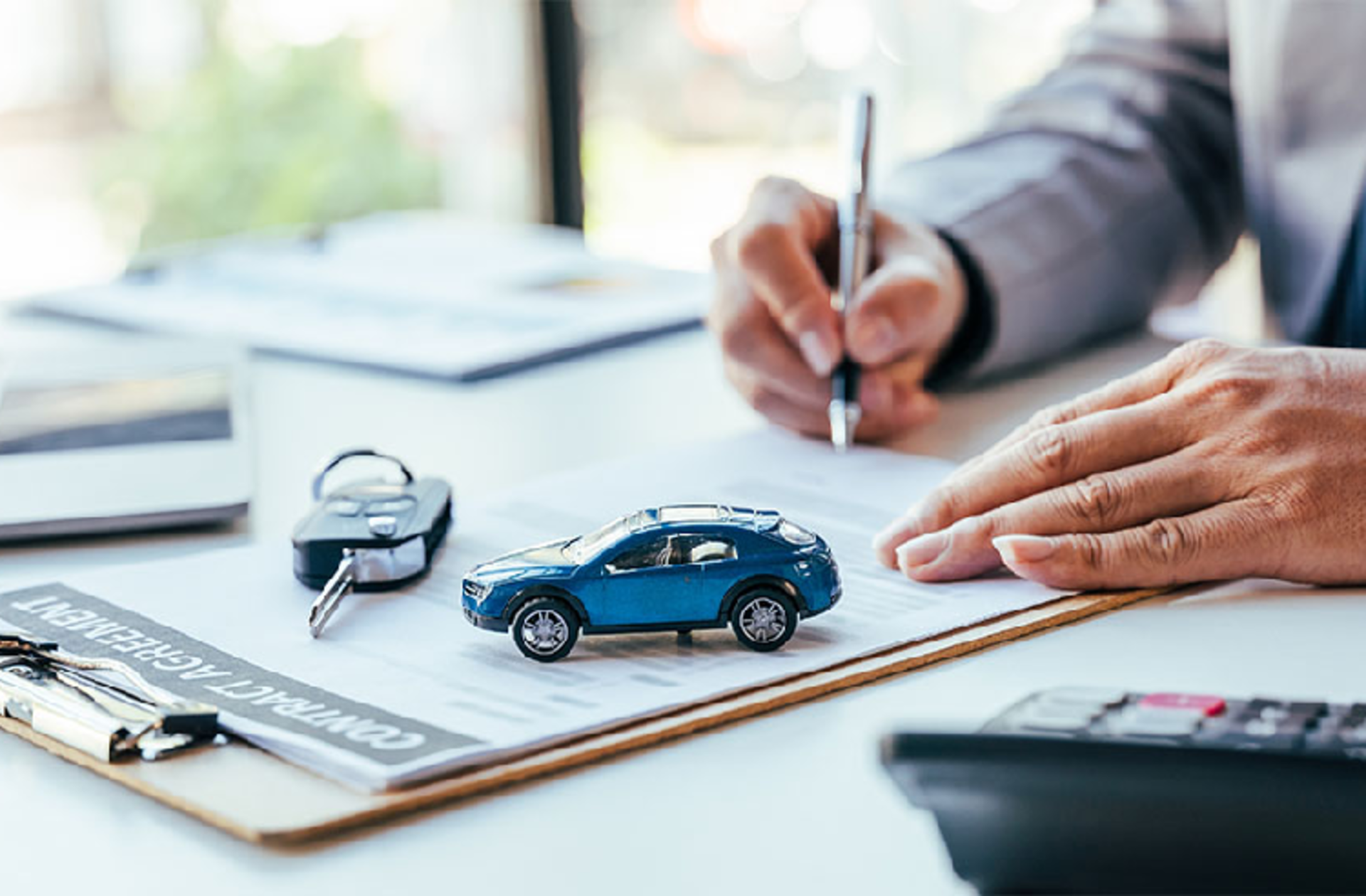 Signing paperwork to buy a car
