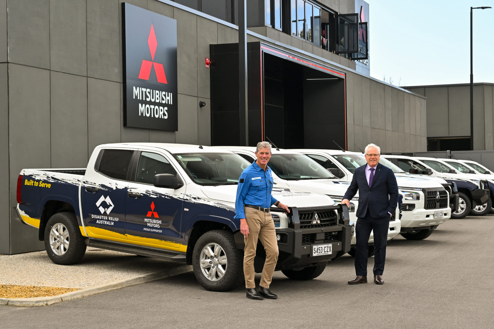 Mitsubishi Motors Australia CEO, Shaun Westcott hands over new Triton fleet to DRA CEO David Smith and his team.