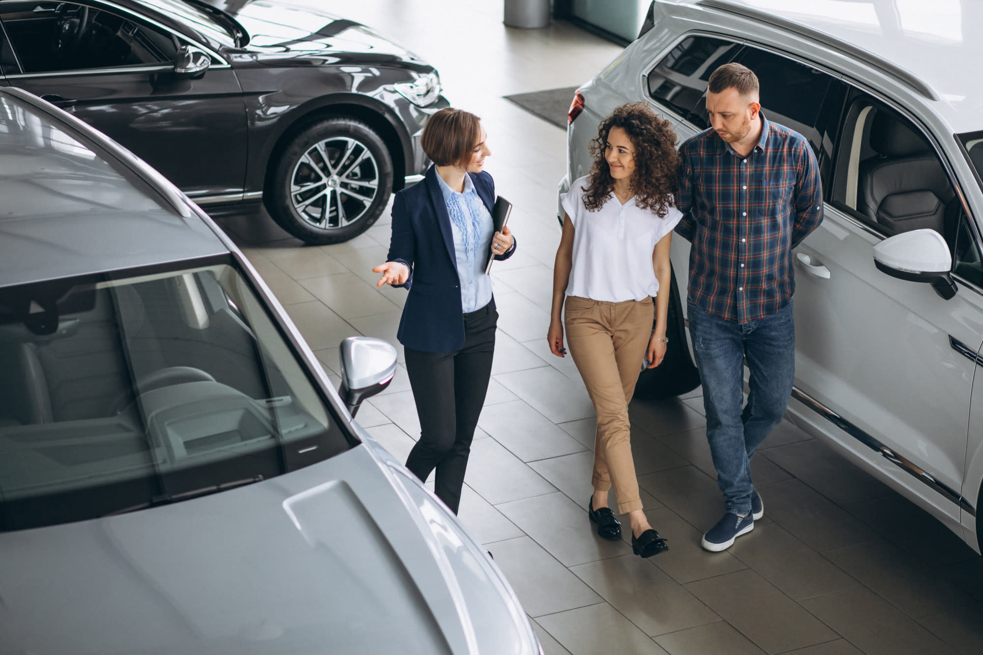 Man and woman shopping in a car showroom