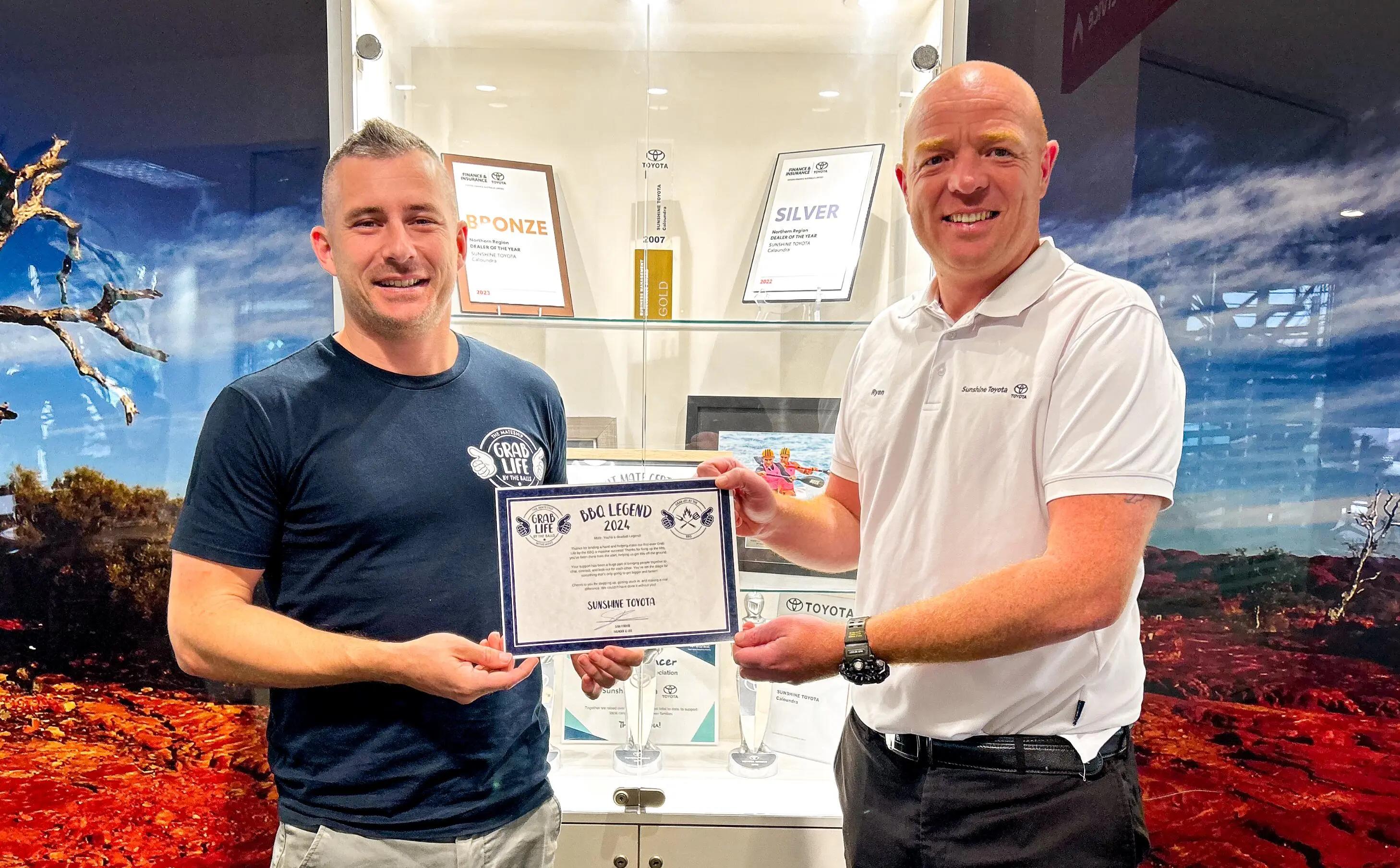 sunshine toyota presenting award to grab life by balls member