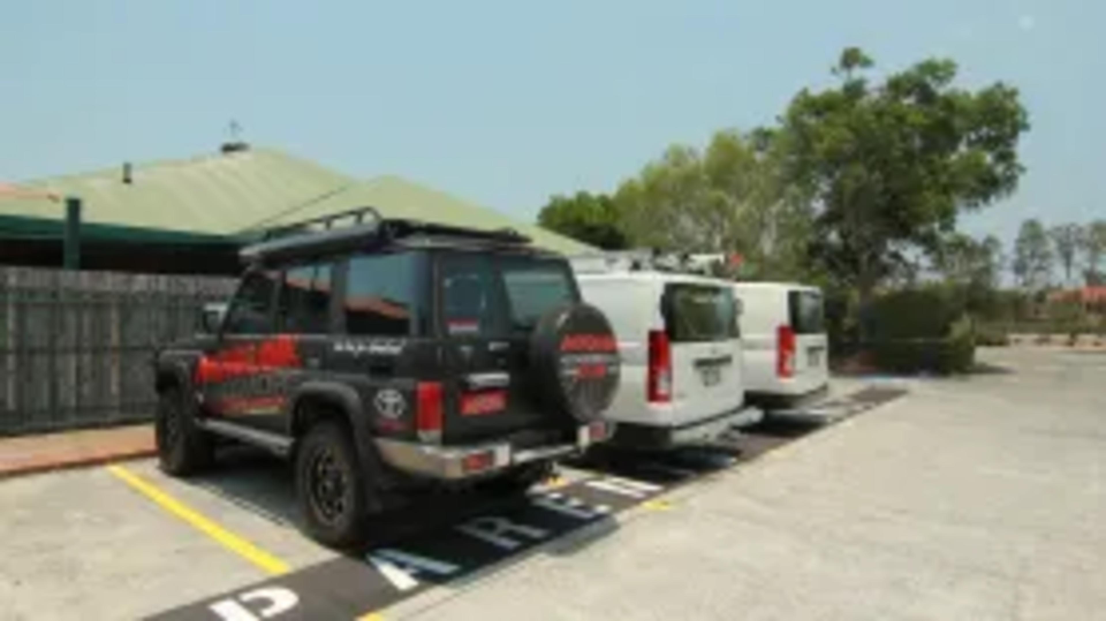 The 4X4XMORE Toyota LandCruiser 76 and two HiAce vans parked outside AB Paterson College in Arundel.