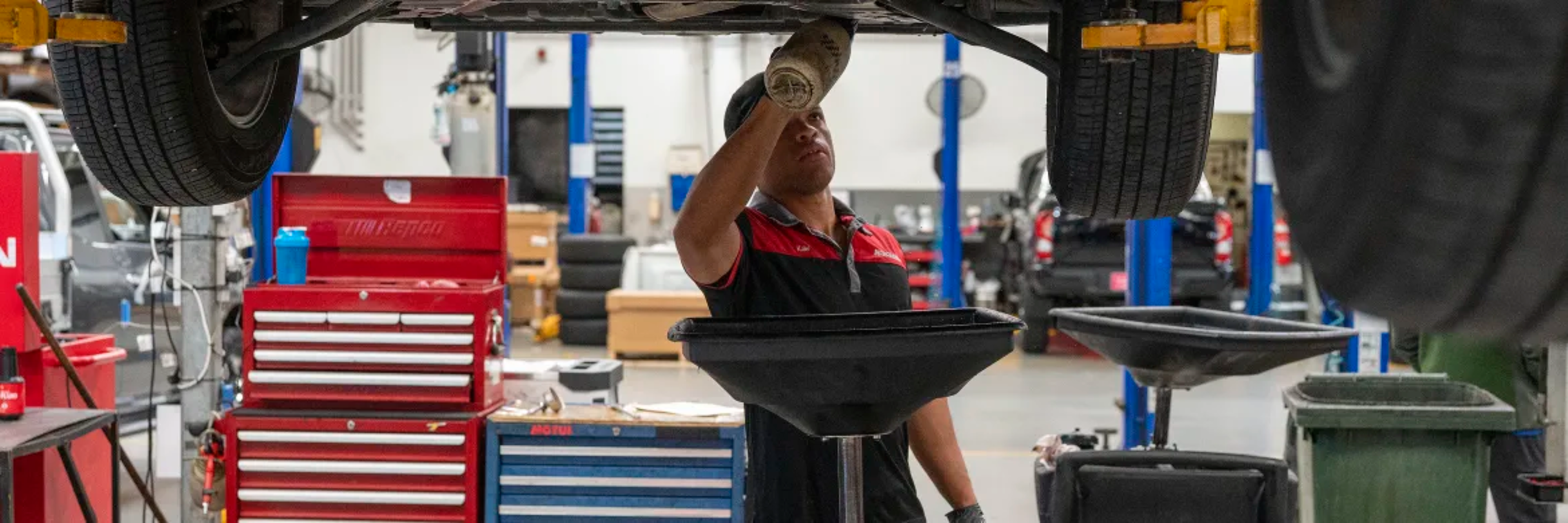 Man servicing Nissan car