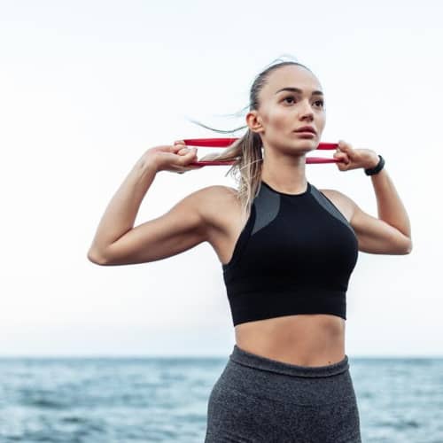 Lifestyle image of the Medium Resistance Exercise Bands in Red from Total Merchandise