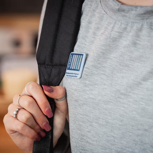 Recycled Biodegradable Plastic Button Badges on a jumper by Total Merchandise