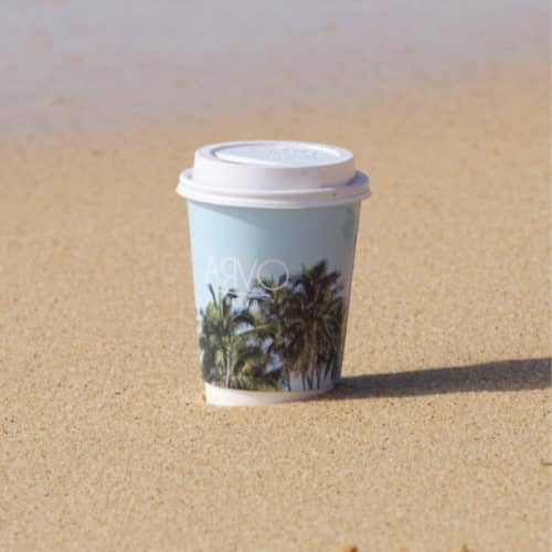 Image of Custom Branded Compostable Paper Cups with Full Colour Image in the Sand