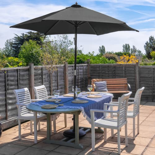 Custom printed 2.5m Black Wooden Parasol in Black over a dining table by Total Merchandise